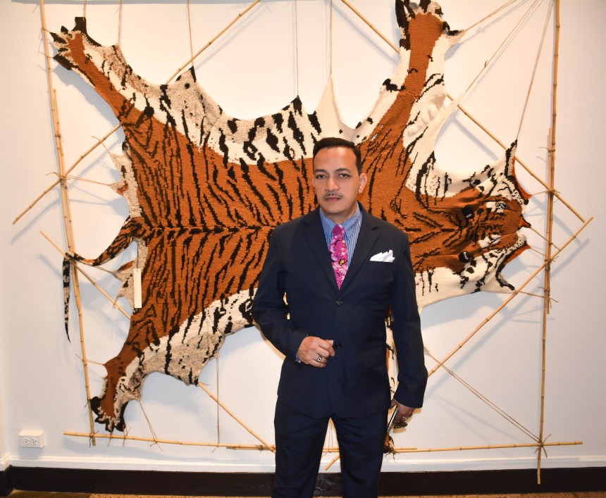 Anthony Rubio in front of a  knitted Tiger at the  Horticultural Society of New York's "Auction Art Work"