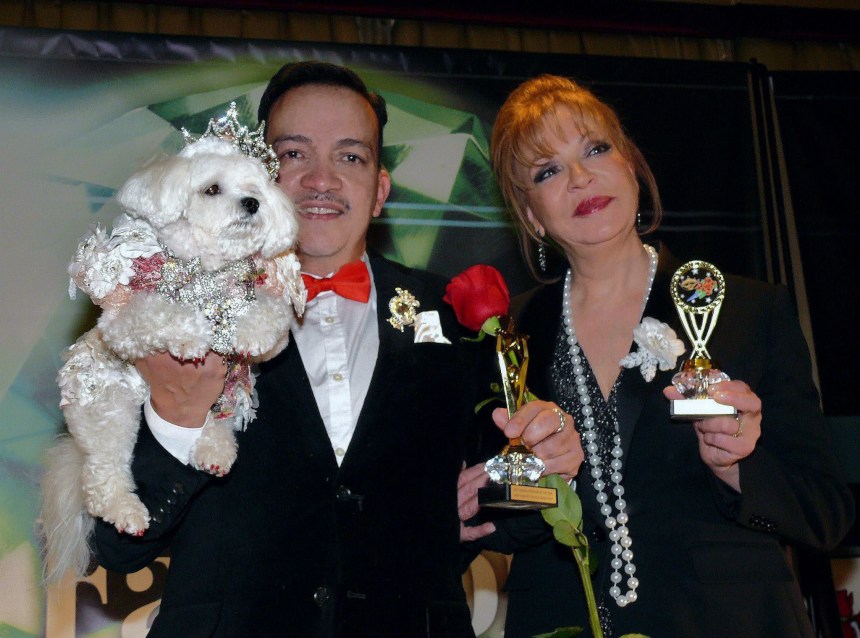 Pet Couturier Anthony Rubio holding Maltese Bella Mia and Rose Ann Bolasny  after  being awarded the Designer Of The Year Award and Best Dressed Dog Award at the New York Pet Fashion Show Photo by Richard Alicea