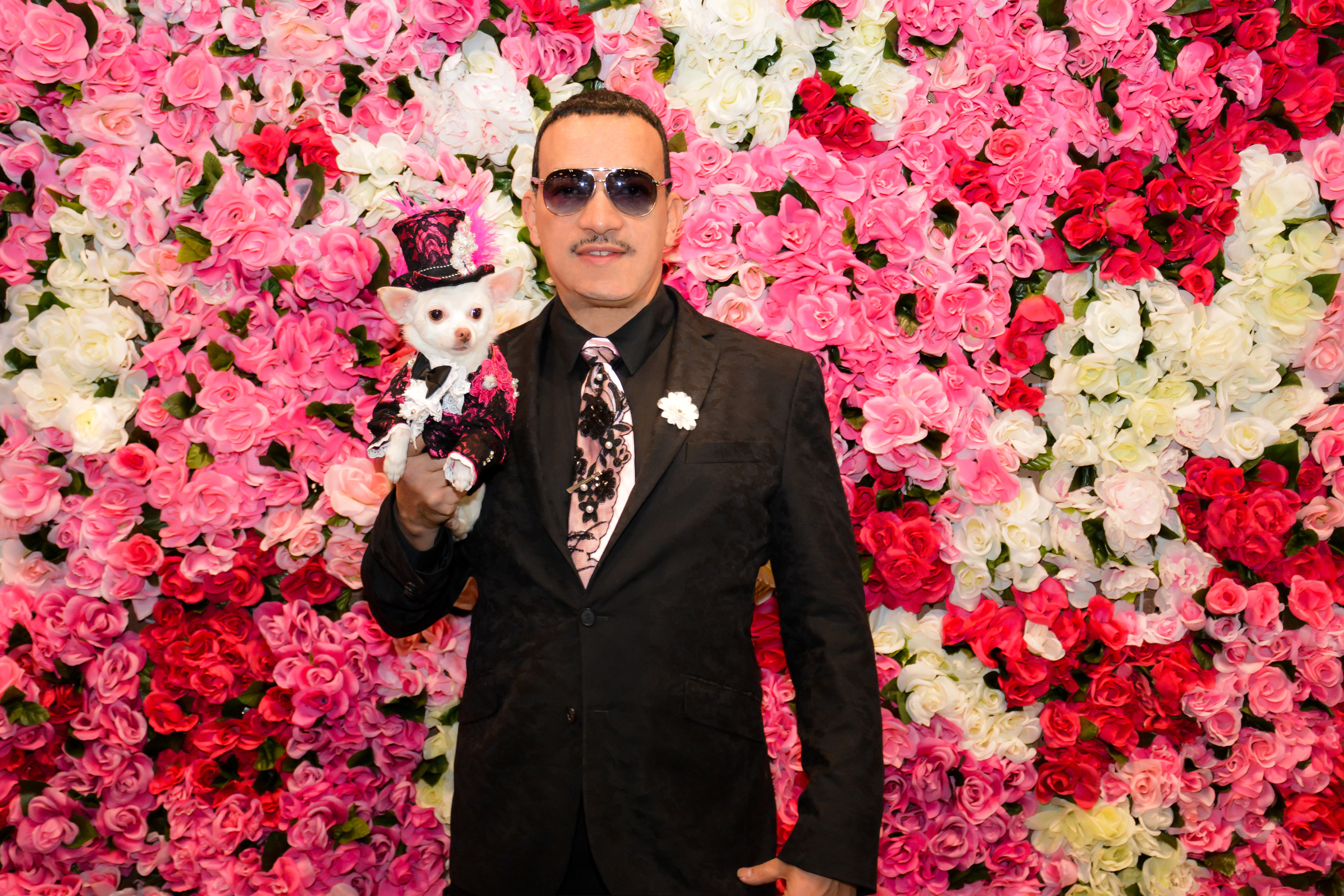 Spring Is In The Air! Pet Couturier Anthony Rubio with his Chihuahua Kimba wearing a pink with black lace overlay tuxedo and matching top hat created by Anthony Rubio.